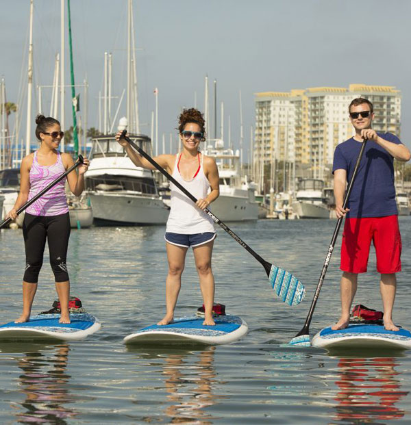 friends enjoying paddle boarding together