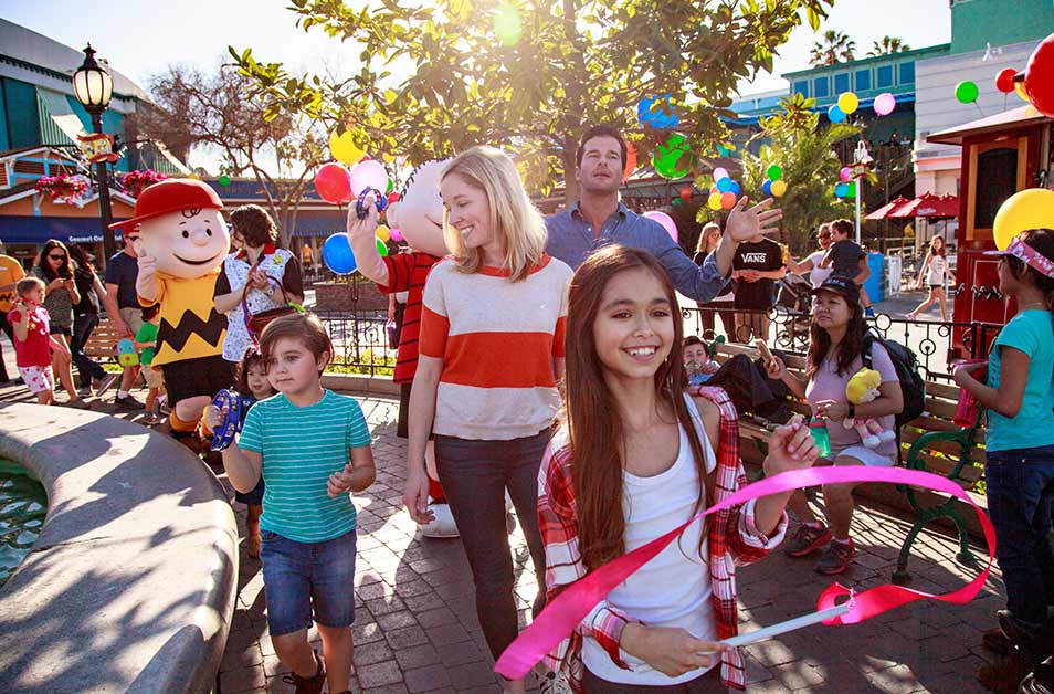 Family smiling and enjoying Knotts Berry Farm theme park, attraction near Marina del Rey